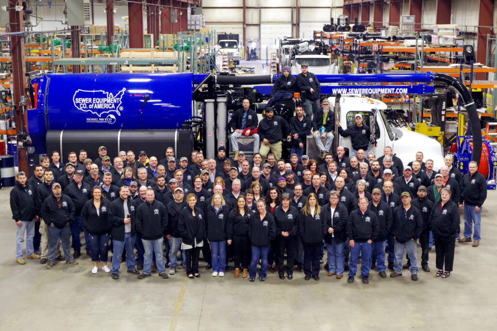 Sewer Equipment's growing staff in front of a new truck