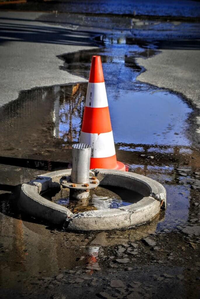 water main break with orange cone